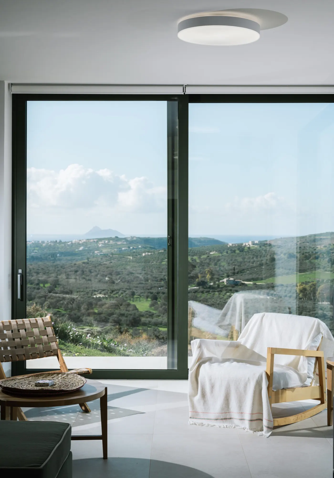 Looking through the Main House windows to the winter-green Messara Valley
