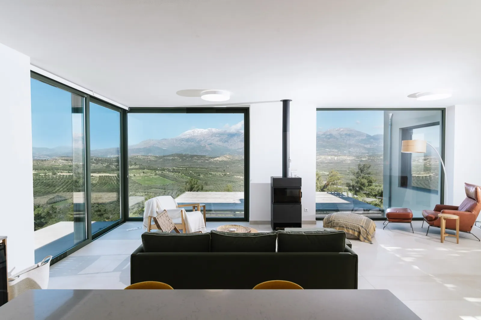Main House open-plan living room with corner glazing and mountain views