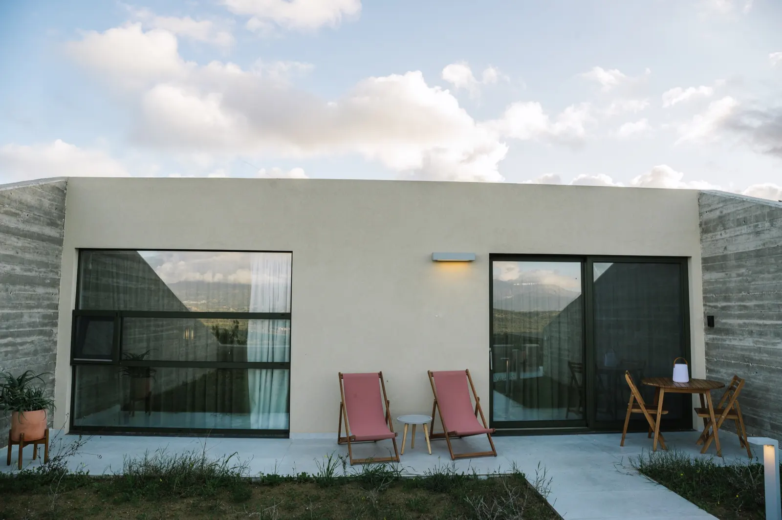 Upper Guesthouse facade with floor-to-ceiling windows and private patio